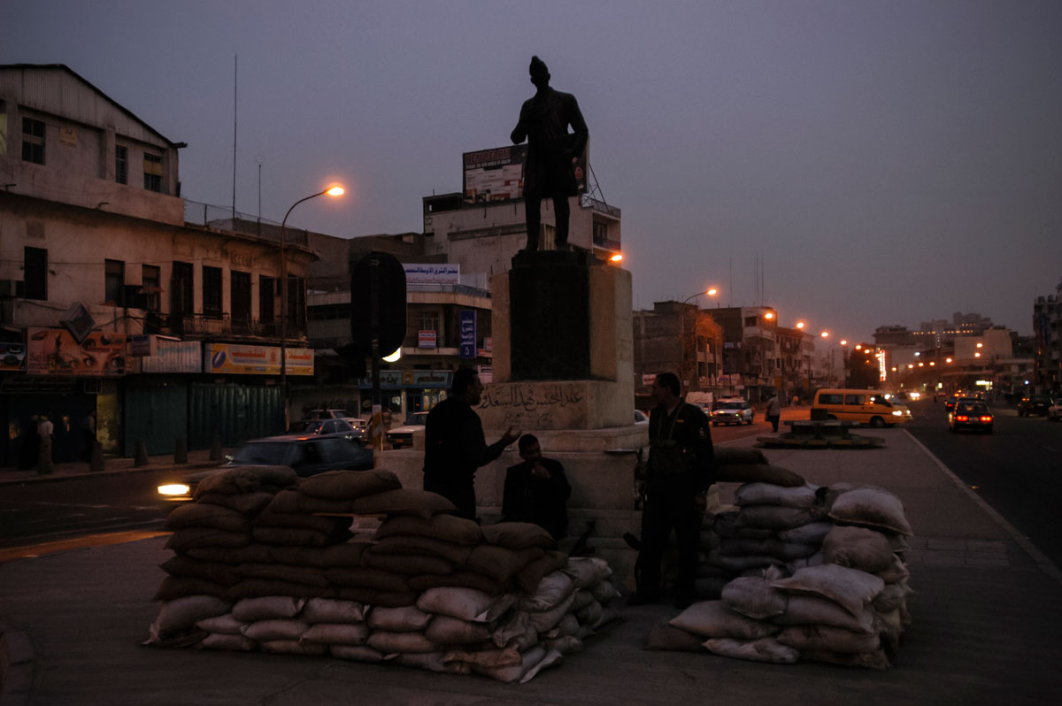 March 19th 2003.
Iraqi volunteers, stand at sandbag positions on Sadoun Street in downtown Baghdad, a few hours before the ultimatum given by President Bush to Saddam Hussein  expires.
 Their defenses seem rudimentary and inadequate to the reality of a conflict.
