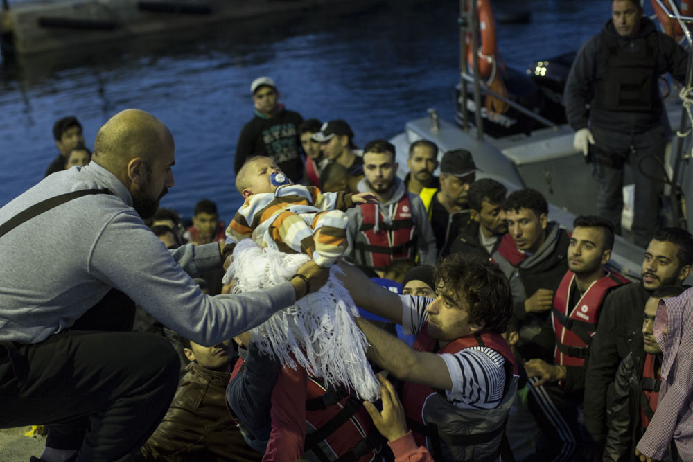 Syria was the most common country of origin. These Syrian parents, travelling with their 4 month-old baby, where rescued at sea by the Greek coast-guards. 
Kos port, Greece. May 26, 2015.