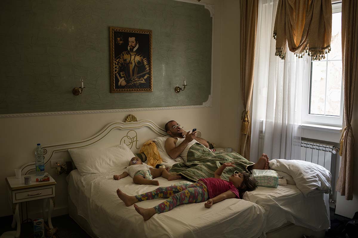 Belgrade, July 9, 2015.
Ahmad is planning the next step in the crossing. He and his wife share a hotel room with their 2 children and their niece.